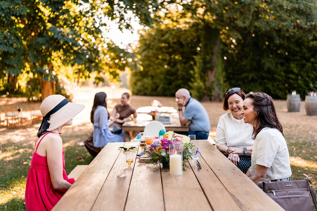 Guests enjoying a relaxed outdoor welcome dinner at Château de Bonnemare in Normandy.