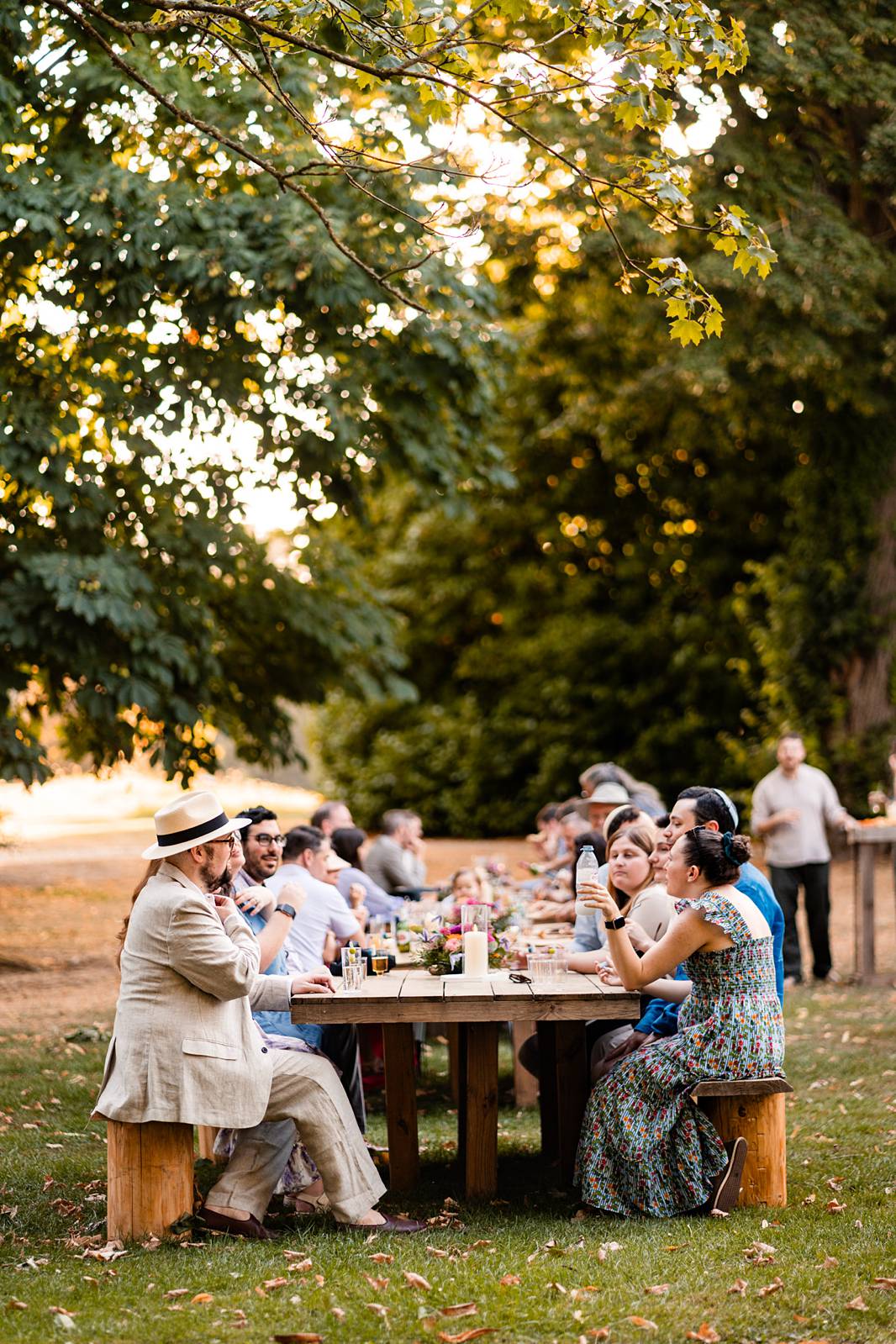 Guests enjoying a relaxed outdoor welcome dinner with wood-fired pizzas at Château de Bonnemare in Normandy.